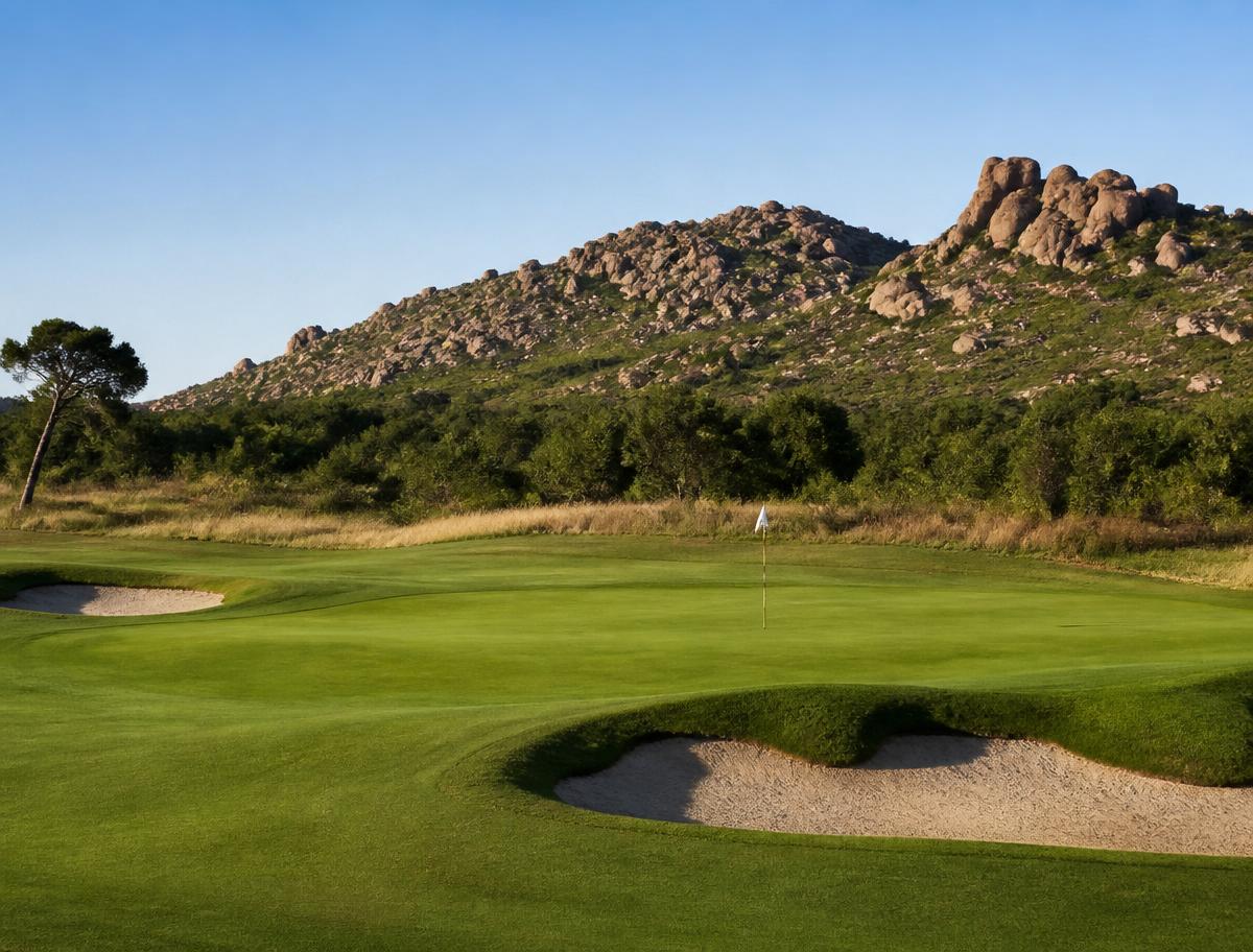 Championship greens with bushveld koppies behind.